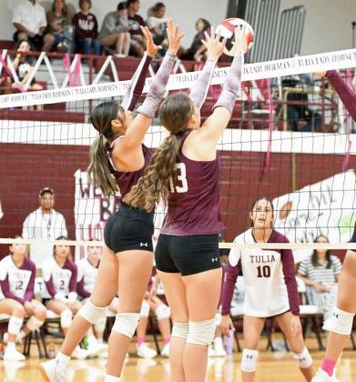 Littlefield’s Nevaeh Lopez and Maggie McNeese combine for a block, during the first set of the Lady Cats, 3-0, victory on the road on Saturday over Tulia in district play. (Staff Photo by Derek Lopez)