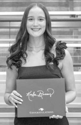 Kealee Bussey receives a scholarship from the Lamb County Electrical Coop.