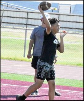 Littleifled Coach, Blake Green, works on throwing drills with a group of campers, during day one of the Wildcat Youth Football Camp on Monday at Wildcat Stadium in Littlefield. (Staff Photo by Derek Lopez)