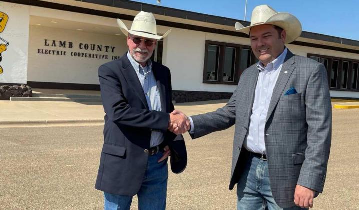 BLAKE MOORE, right, IS WELCOMED TO LAMB COUNTY ELECTRIC COOPERATIVE. Retiring Boyd McCamish, who served LCEC 47 years, extends his best wishes to Moore on his new venture.