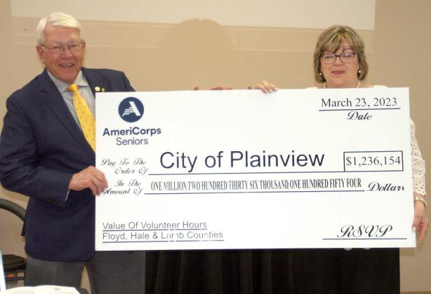 Plainview Mayor Charles Starnes accepts a check from RSVP director, Charlotte Schumacher for the value of the volunteer hours in 2022. (Submitted Photo)