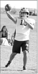 Springlake-Earth’s Bryan Longoria works on timing with his receivers, during the first week of two-adays this past week. (Staff Photo by Derek Lopez)