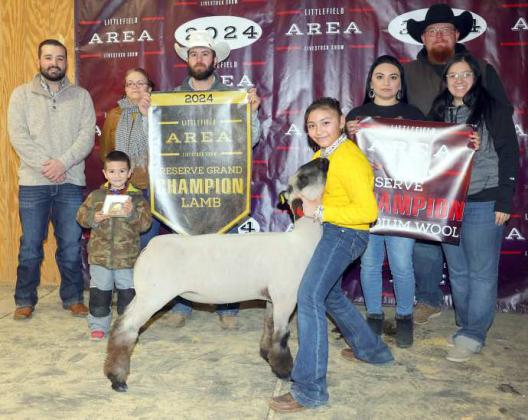 Ruby Macias of Amherst FFA won Reserve Grand Champion Lamb at the Littlefield Area Junior Livestock Show on Friday at the Lamb County Ag Center. Shown with Judge Walker Hemphill (left). (Photo by MD Creations)