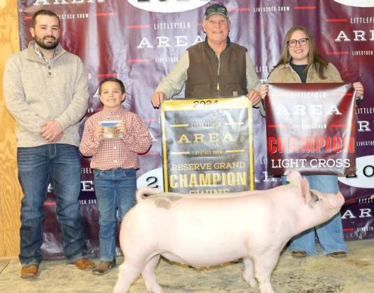John Michael Hill of Sudan FFA won Reserve Grand Champion Swine at the Littlefield Area Junior Livestock Show on Friday at the Lamb County Ag Center. Shown with Judge Walker Hemphill (left). (Photo by MD Creations)