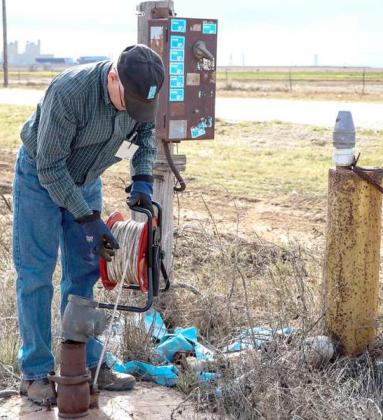 FIELD STAFF SUPERVISOR KEITH WHITWORTH MAKES A WATER LEVEL MEASUREMENT IN A PRIVATELY-OWNED OBSERVATION WELL WITHIN THE DISTRICT. (Photo courtsey of HPWD)