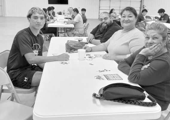 Members of the Wildcat varsity football team play bingo and visit with senior citizens, who attended the Sisters of Hope and Grace quarterly free meal on Sunday at the Lamb County Ag Center. Shown are Andrew Espinoza and Sammy Saenz. (Submitted Photos)