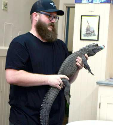 Jarrod Dale of Walter’s World of Pets explains that the African Dwarf Crocodile he is holding will not be sold as a pet. It is part of an important program to keep its species from going extinct. (Photo by Ann Reagan)