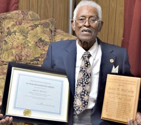 JOHN D. MCCARTY receives Award for 60 Year’s of Service, and a lapel pin from the Texas Funeral Directors Association. On the right he displays the Lifetime Achievement Award from the Littlefield Chamber of Commerce. (Photo by Ann Reagan)