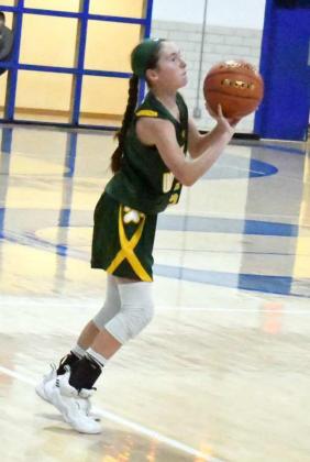 FIRING FROM RANGE – Springlake-Earth sophomore, Taytum Goodman (5), fires up an open three from the right elbow, during the first half of the Lady Wolverines’ one-point loss to the Fillies on Tuesday. (Staff Photo by Derek Lopez)
