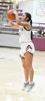 Littlefield’s Arianna Cruz fires up a deep three from the left elbow, during the first half of the Lady Cats’, 35-31, district victory over Lamesa on Friday at Wildcat Gym. (Staff Photo by Derek Lopez)