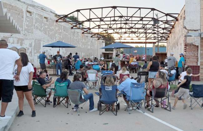 People gathered at the Pocket Park on Phelps Ave. to listen to the Legal Limit Band during the Free Block Party that kicked off the Flatland Music Festival Weekend. (Photo by Ann Reagan)