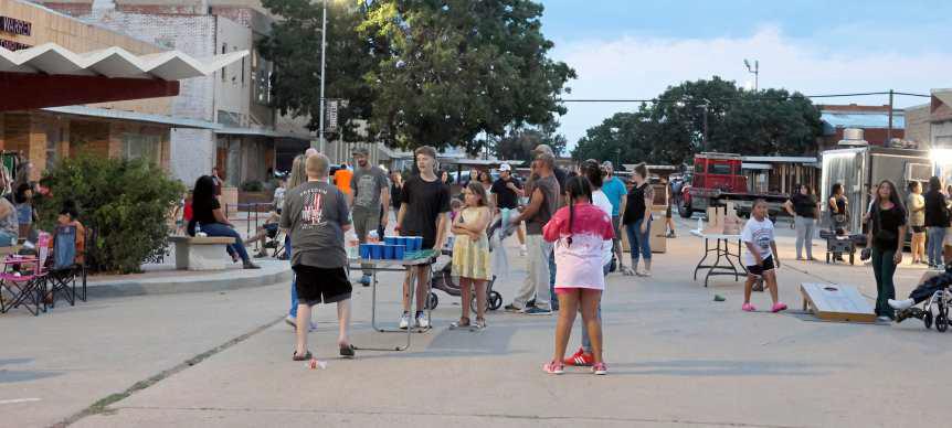 People of all ages came to hang out, play games and listen to live music, during the Friday Night Block Party that kicked off the Flatland Music Festival weekend. (Photo by Ann Reagan)