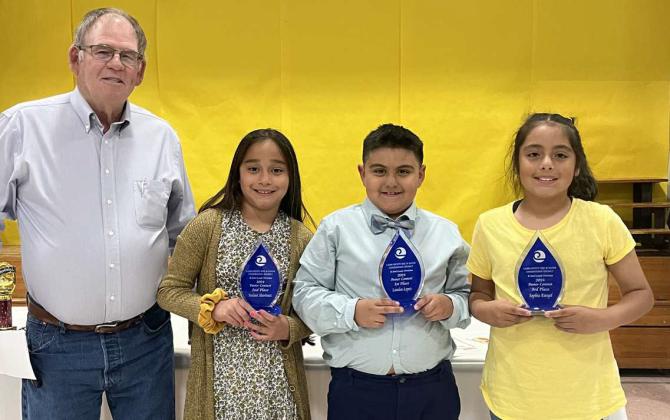 The winners of the Lamb County SWCD Poster Contest K-2nd Grade Division were (L-R): Roy Thompson- Lamb Co. SWCD Board Vice-Chairman, 2nd Place Winner: Nalani Martinez, 1st Place Winner: Landen Lopez and 3rd Place Winner: Sophia Rangel. This year’s theme was “May the Forest Be with You Always”. (Submitted Photo)