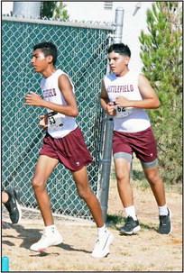 Littlefield’s Ayden Arredondo and Carlos Almance pace themselves through the course at the Littlefield Invitational last Saturday. (Staff Photo by Derek Lopez)