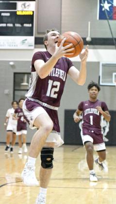 Littlefield junior, Chip Green, gets out on the break and drops in a lay-up in transition, during the first half of the Wildcats’, 86-43, victory over Muleshoe on the road Tuesday night in district play. (Staff Photo by Derek Lopez)