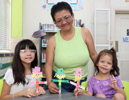 Bonnie Black age 10, Jessica Martinez and Ceili Black age 7 show off the crafts they made at the Lamb County Library on Thursday, August 4, 2025. (Photo by Ann Reagan)