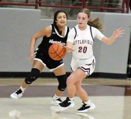 PLAYING THE PASSING LANE - Littlefield junior, Kennadi Hanlin (20), intercepts a pass and takes it the other way for the fast break, during the first half of the Lady Cats’, 47-42, victory over Herford on Tuesday at Wildcat Gymnasium. (Staff Photo by Derek Lopez)