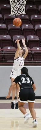 FIRING FROM RANGE - Maerysa Saenz (11) puts up a three from the right wing over the closing Hereford defender, during the first half of the Lady Cats’, 47-42, victory over Herford on Tuesday at Wildcat Gymnasium. (Staff Photo by Derek Lopez)