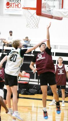 Littlefield guard, Jeremiah Trevino (8), drives the left side of the basket for a lay-up, durng a summer basketball game against Roosevelt at New Home last Friday. The Wildcats defeated the Eagles, 59-30. (Staff Photo by Derek Lopez)