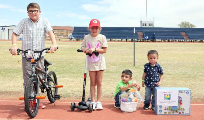The following were the winners of the raffle items. (Left to Right): The winner (3rd - 5th grade) of the bicycle donated by Proforma LaDuke, Brinn Redwine is the winner (1st - 2nd grade) of the†scooter donated by Texas Best Bean and Seed, the winner (Special Needs Kids category) of one of the sensory toys baskets donated by Valley Ag Electric, and Rosendo Alcaraz IV is the winner (kindergarten and under) of the water table donated by Ramage Funeral Directors. (Photos Courtesy of Olton Chamber of Commerce)