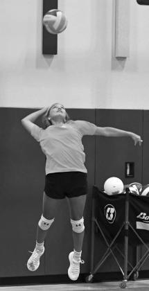 The Littlefield’s Cobi Saldana sends a serve during a scrimmage, during the Lady Cat’s Midnight Madness practice to open two-a-days Monday morning. (Staff Photos by Derek Lopez)