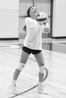 The Littlefield’s Madison Williams bumps the ball up in the air to keep a play alive, during a scrimmage, during the Lady Cat’s Midnight Madness practice to open two-a-days Monday morning. (Staff Photos by Derek Lopez)