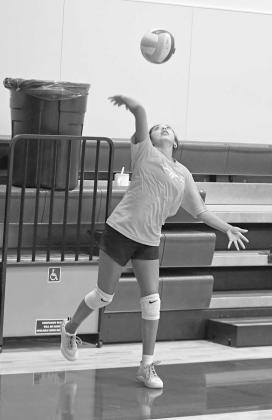 The Littlefield’s Anaei Ojeda sends a serve during a scrimmage, during the Lady Cat’s Midnight Madness practice to open two-a-days Monday morning. (Staff Photos by Derek Lopez)