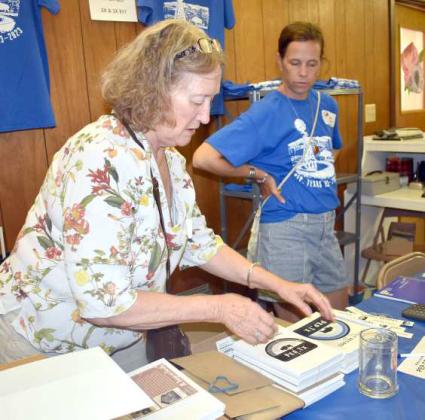 COOKBOOKS AND T-SHIRTS -- Centennial Cookbooks and TShirts were available for purchase during the Pep Centennial Celebration that was held on Saturday, Aug. 5, 2023. (Photo by Emily Campos)