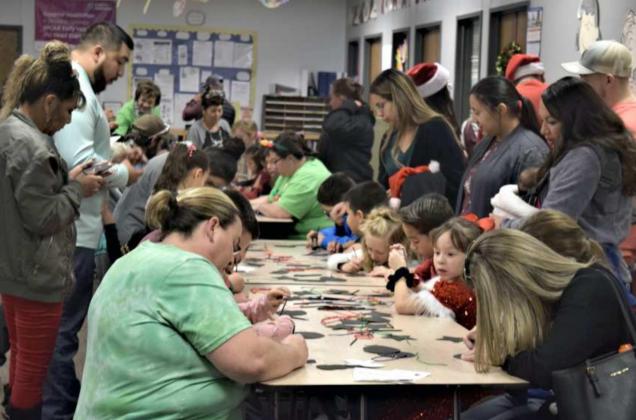 Parents sit down to do arts and crafts with their children during the Littlefield Primary School Christmas Family Night that was held on Dec. 13th. (Photo by Ann Reagan)