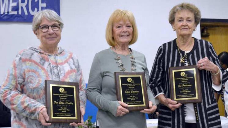 CITIZENS OF THE YEAR – These three women of the Amherst Community were honored for their past years of community service in going to the Amherst School to read to students, to help them gain skills to learn to read. Each was introduced by Robyn Patterson, before they were presented their award plaques. Shown, left to right, with their plaques, are Sue Ellen Priddy, Dixie Sanders and Joy Patterson. (Staff Photo by Joella Lovvorn)