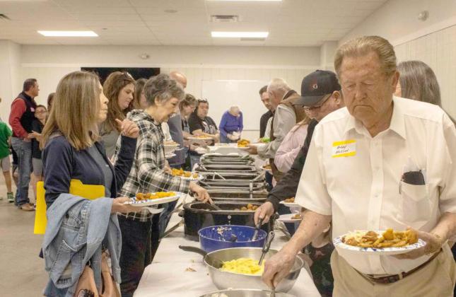 Guests serve themselves fish and sides at the 16th annual Fish Fry on April 19, 2025. (Photo by Madison Vidales)