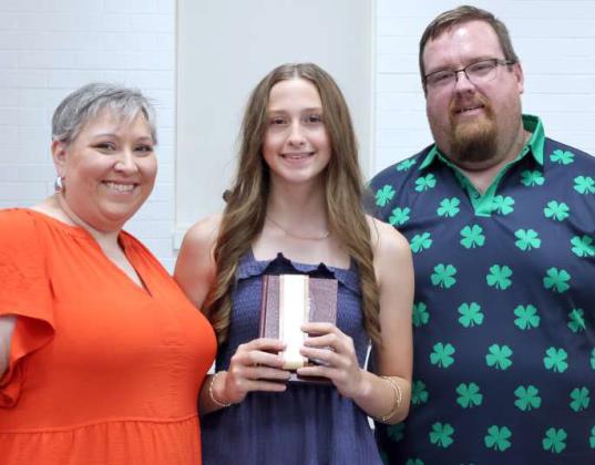 Kathy Lostroh and Brandon Albus presented the second recipient of the 'I Dare You' Award to Piper Carr during the Lamb County 4-H Awards Banquet. (Photo by Ann Reagan)