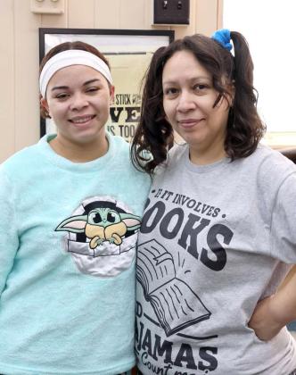 Lamb County Librarians Ambrosia Simpson and Selena Sanchez dressed in their finest pajamas for the “Pajamas, Pancakes, and Puzzles” event at the Lamb County Library. (Photo by Ann Reagan)