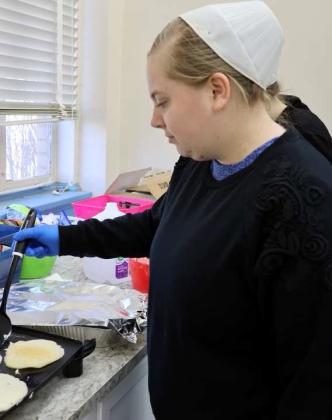 These young ladies volunteered to cook pancakes for the Lamb County Library “Pajamas, Pancakes, and Puzzles” event on Saturday, January 27, 2024. (Photo by Ann Reagan)