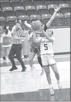 Littlefield’s Madison Williams (5), goes up for a tough lay-up through contact from Friona’s Aaliyah Padilla, during the first half of the Lady Cats’ win Tuesday night. (Staff Photo by Derek Lopez)
