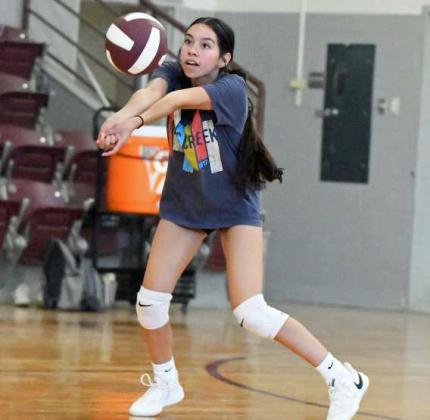 A group of Littlefield Lady Cat volleyball players work on moving laterally while hitting and receiving the ball, during their first day of two-a-days on Monday. (Staff Photo by Derek Lopez)
