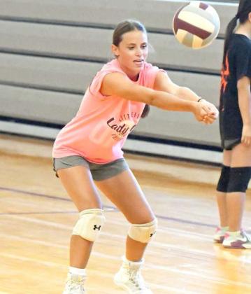 Littlefield Lady Cat Bryndle Ray works on hitting and receiving the ball while backing up, during their first day of two-a-days on Monday. (Staff Photo by Derek Lopez)