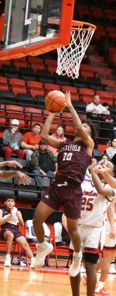 GOING UP STRONG - Littlefield guard, MJ Randle (20), goes up strong for a lay-up during the second half of the Wildcats’ double overtime loss on the road to the Lobos on Tuesday. (Staff Photo by Derek Lopez)