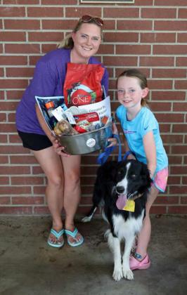 The winner of the Large Dog Basket Donated by Adri’s Kitchen, was Toby with his owner Reeslyn Riney and her mother Hayli Riney at the Dog Show that took place on Friday at the 44th annual Sandhills Celebration. (Photo by Wesley Quigley)