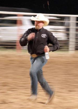 Step 3-Runner takes the bottle of milk to the finish line in the Wild Cow Milking event at the Earth, Tx WRCARodeo on Friday, September 20, 2024. (Photo by Ann Reagan)