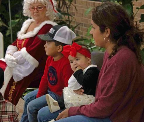 Families wait for their turn for a picture with Santa at LHC on Thursday afternoon. (Staff Photo by Madison Vidales)