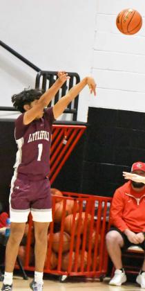 Littlefield’s Jayden Barrio (1), puts up a three from the left elbow, during the first half of the Wildcats’ loss to the Tigers in their districtopener in Slaton on Tuesday. (Staff Photo by Derek Lopez)