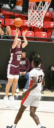 Littlefield’s Chip Green (12), fires up a three from the right elbow, during the second half of the Wildcats’ loss to the Tigers in their district-opener in Slaton on Tuesday. (Staff Photo by Derek Lopez)