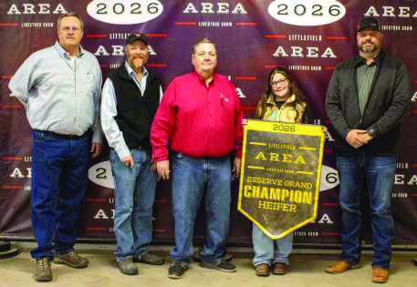 Reserve Grand Champion Heifer winner Rainey Hays poses with buyers from First United Bank, Lance Insurance, Lamb County Farm Bureau, Indian Ink Leasing, Caprock Dairy, Earth Fertilizer and Spraying and Lowe's.