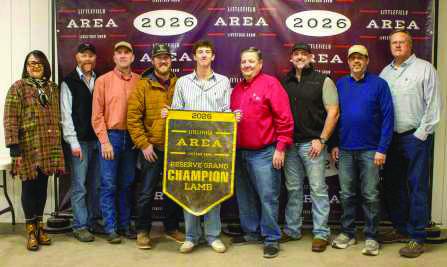Reserve Grand Champion Lamb winner Kooper Edwards poses with buyers from First United Bank, Kyle and Darleana Robertson, WDG Trucking, Boehning Dairy, Lamb County Farm Bureau, Corteva Agriscience, Sawyer Construction, Indian Ink Leasing, 2-Step Cattle, Lowe's and Hereford Grain.
