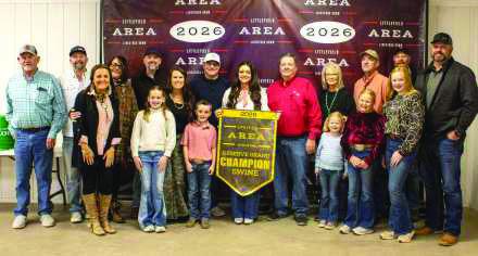 Reserve Grand Champion Swine winner Emry Humphreys poses with buyers from Boehning Dairy, Kyle and Darleana Robertson, Lance Insurance, Lamb County Farm Bureau, Jeff and Jennifer Edwards, Sawyer Construction, Lamb County Electric, Jerry and Cheryl Sowder, Texas Producers Co-Op, Hill's Service Center, Kroslessyn Aerial, Lowe's and Hereford Grain.