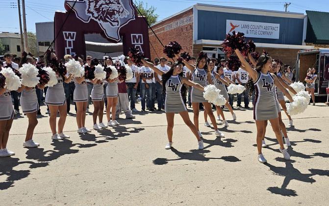 The Littlefield High School Varisyt and JV cheerleaders performed at the 21st annual Wildcat Street Party Last Friday, which was held on Phelps Avenue in front of Wellington State Bank. (Staff Photo by Derek Lopez)