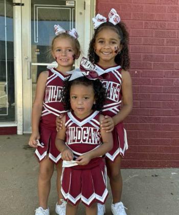 Shown are Makay McNeese, Natalia Lopez and Kiyah Elliott dressed in their Wildcat Cheer suits at the 21st annual Wildcat Street Party Last Friday. (Staff Photo by Derek Lopez)
