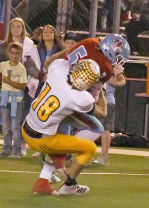 GETT1NGA STOP— SpringlakeEarth junior, Trace Goodman (18), brings down Borden County’s Mason Cole, during the first quarter of the Wolverines, Regional play-off loss at Slaton on Friday. (Staff Photo by Derek Lopez)