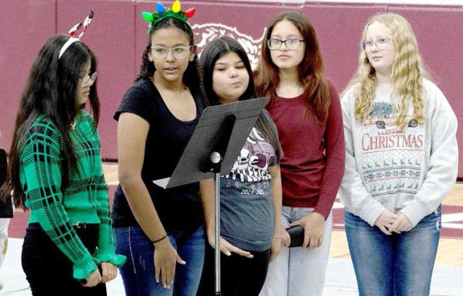 Littlefield Band members recite a story as the band plays at the Christmas Band Concert on Dec. 10, 2024. (Photo by Rhode Duenas)